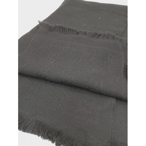 671 - A Gucci Wool Silk GG Monogram Fringe Scarf in Black, featuring the iconic GG monogram pattern throug... 