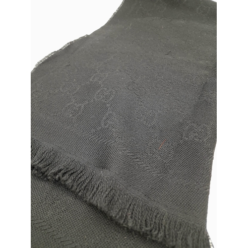 671 - A Gucci Wool Silk GG Monogram Fringe Scarf in Black, featuring the iconic GG monogram pattern throug... 