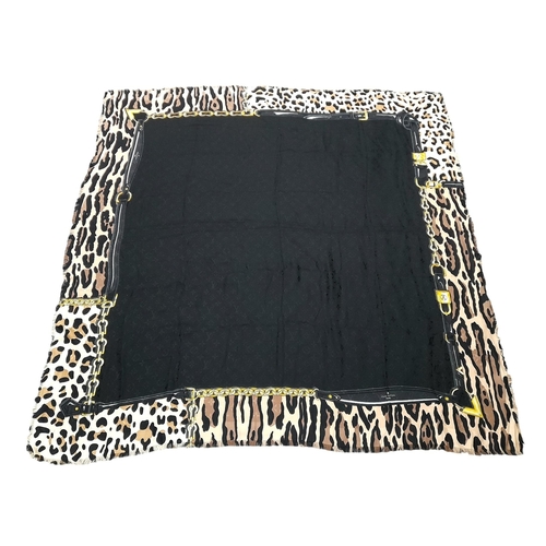 755 - A Louis Vuitton Silk Wool Leopard Monogram Scarf. Featuring the LV monogram pattern bordering the fa... 