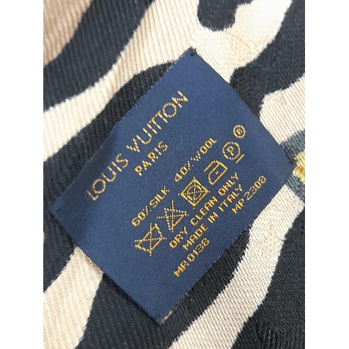 755 - A Louis Vuitton Silk Wool Leopard Monogram Scarf. Featuring the LV monogram pattern bordering the fa... 