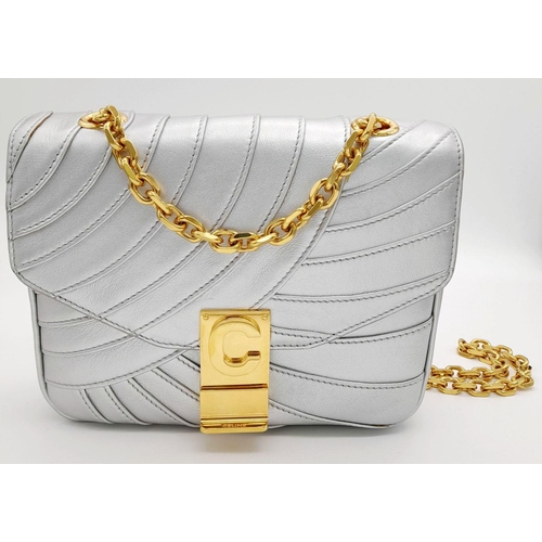 819 - A Celine Metallic Silver Quilted Shoulder Bag. Metallic silver leather exterior with quilted detaili... 