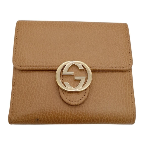 952 - A Gucci Brown Bifold Purse/Wallet. Gold-toned hardware with interlocking G logo and press stud closu... 