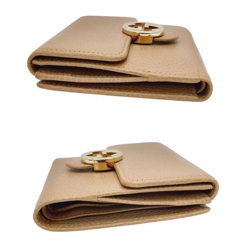 952 - A Gucci Brown Bifold Purse/Wallet. Gold-toned hardware with interlocking G logo and press stud closu... 