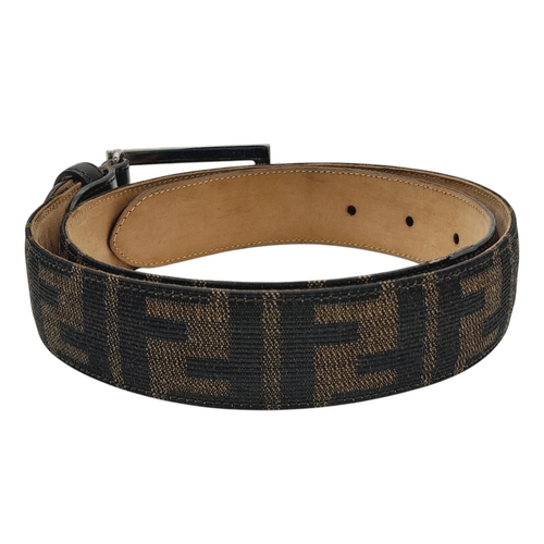 1050 - A Fendi Zucca FF Buckle Belt. Classic Zucca monogram canvas with black leather trim and a beige leat... 