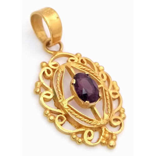 684 - A Mesmerising 22K Gold Decorative Pendant with an Oval Cut Central Spinel. 4cm. 5.25g total weight.