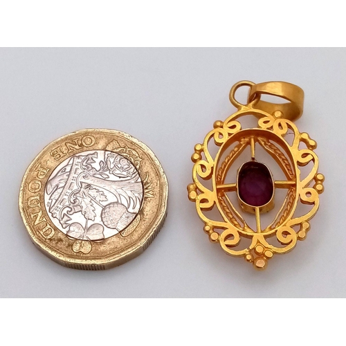 684 - A Mesmerising 22K Gold Decorative Pendant with an Oval Cut Central Spinel. 4cm. 5.25g total weight.