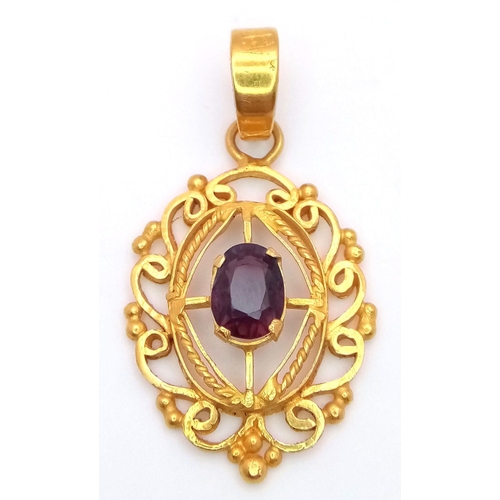 684 - A Mesmerising 22K Gold Decorative Pendant with an Oval Cut Central Spinel. 4cm. 5.25g total weight.