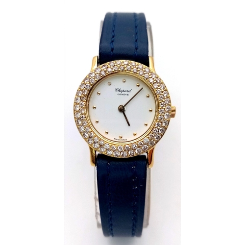 79 - An 18K Gold and Diamond Chopard Ladies Quartz Watch. Blue leather strap. 18k gold case with two halo... 