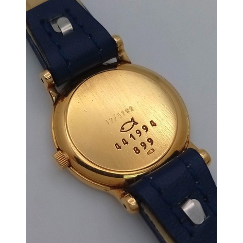 79 - An 18K Gold and Diamond Chopard Ladies Quartz Watch. Blue leather strap. 18k gold case with two halo... 