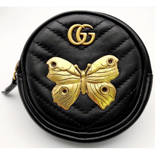 717 - A Gucci Butterfly Carry Pouch. Circular form with butterfly and monogram decoration. Velcro strap. 9... 