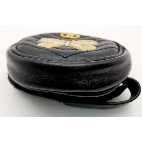 717 - A Gucci Butterfly Carry Pouch. Circular form with butterfly and monogram decoration. Velcro strap. 9... 