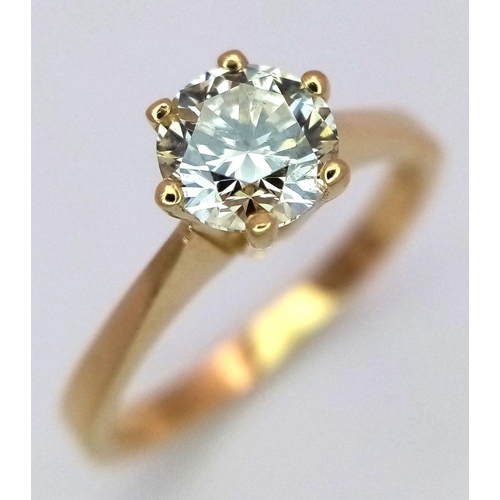 471 - An 18K Yellow Gold Diamond Solitaire Ring. A 0.75ct brilliant round cut diamond - SI1 clarity. Tinte... 