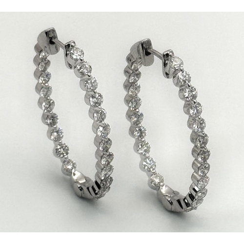 680 - A Pair of 18K White Gold and Diamond Oval Hoop Earrings. 48 diamonds in total - 2ctw approx. 6.3g to... 