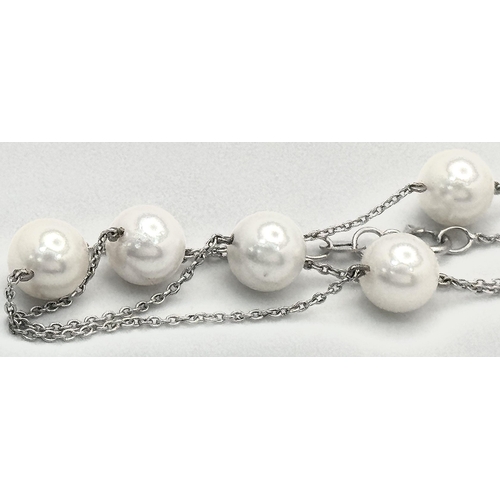 764 - An 18K White Gold Necklace with Nine Pearl Decoration. 7.4g total weight. Pearls, 7/8mm. 44cm length... 