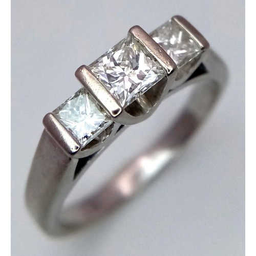 1045 - An 18K White Gold Three Stone Diamond Ring. 0.80ctw of Princess cut diamonds - SI1 clarity. Size L. ... 