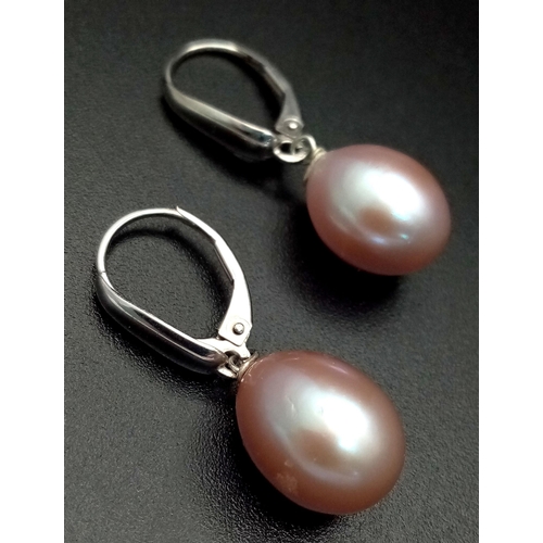 1645 - A Pair of 14K Gold Pastel Pink Pearl Earrings. Large oval pearls - 12mm. 4.8g total weight.