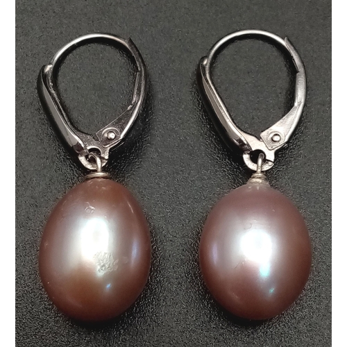 1645 - A Pair of 14K Gold Pastel Pink Pearl Earrings. Large oval pearls - 12mm. 4.8g total weight.