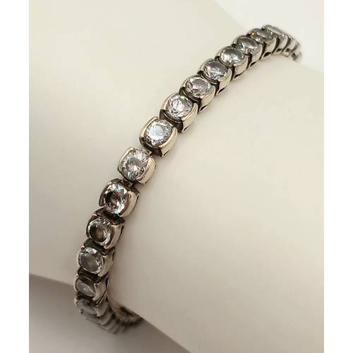 1392 - A Vintage Silver and Clear Stone Tennis Bracelet. 20cm Length. Bracelet width is 4mm. Gross weight 1... 