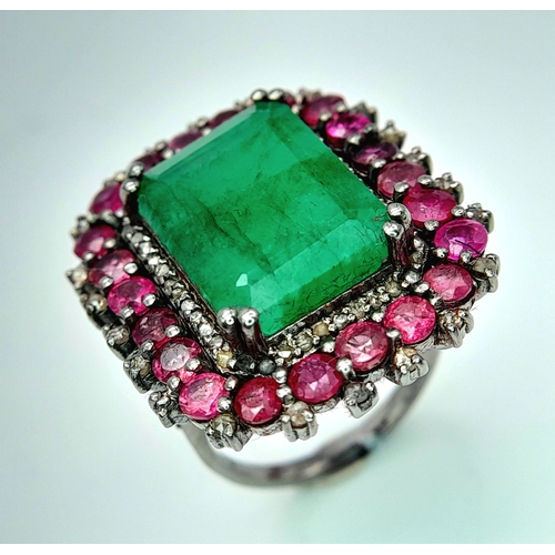 163 - An Emerald, Ruby and Diamond Dress Ring. Set in 925 Silver. Ruby weight 3ctw, emerald weight 10ct. D... 