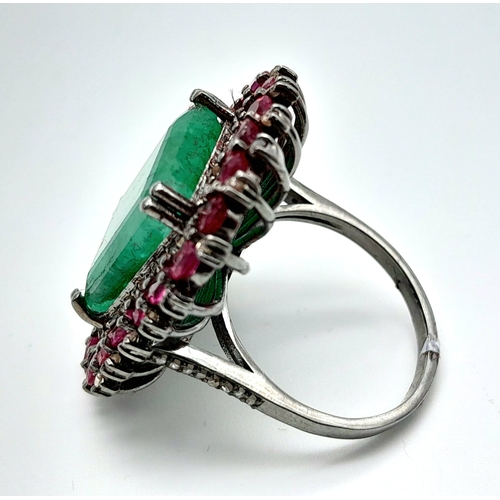 163 - An Emerald, Ruby and Diamond Dress Ring. Set in 925 Silver. Ruby weight 3ctw, emerald weight 10ct. D... 