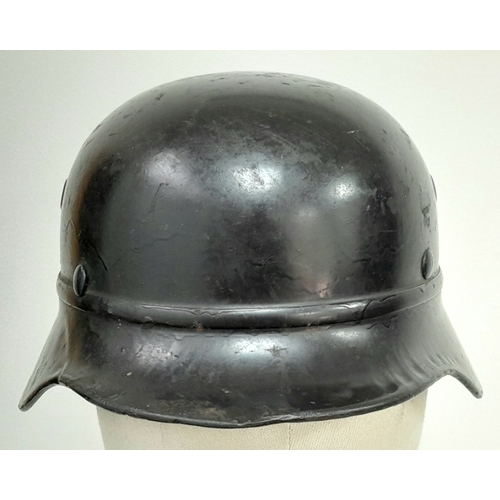 180 - A 3rd Reich M35 Beaded Civic Auxiliary Helmet with chin strap and liner.