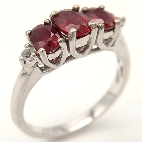 893 - A Sterling Silver Ruby Set Trilogy Ring Size O1/2. The Ring is set with three Oval Cut Rubies the la... 