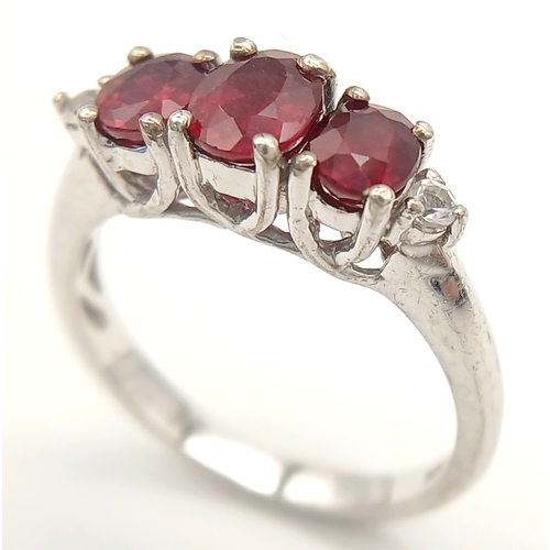 893 - A Sterling Silver Ruby Set Trilogy Ring Size O1/2. The Ring is set with three Oval Cut Rubies the la... 