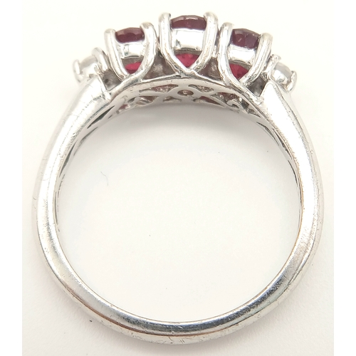 893 - A Sterling Silver Ruby Set Trilogy Ring Size O1/2. The Ring is set with three Oval Cut Rubies the la... 