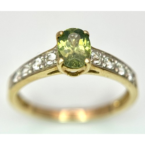 7 - Beautiful 9 CARAT GOLD and PERIDOT RING. Nicely set,having an oval cut PERIDOT mounted to top with W... 