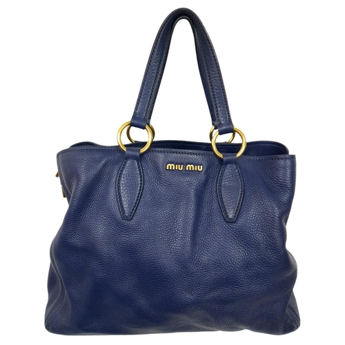 1312 - A Miu Miu Vitello Caribu Top Handle Bag. Blue leather exterior with gold-toned hardware, double stra... 