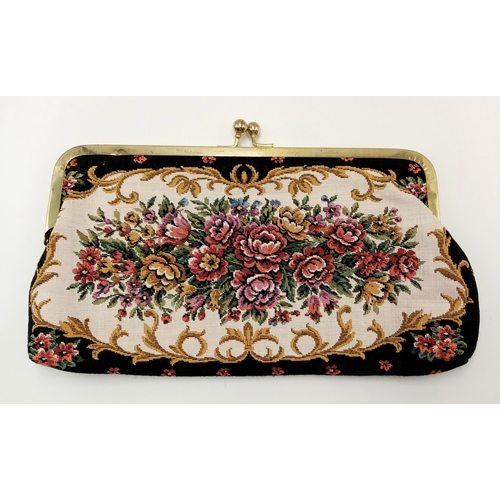 1416 - A vintage tapestry-style handbag featuring an ornate floral design with gold-tone metal frame and cl... 