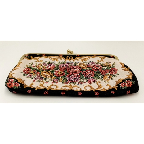 1416 - A vintage tapestry-style handbag featuring an ornate floral design with gold-tone metal frame and cl... 