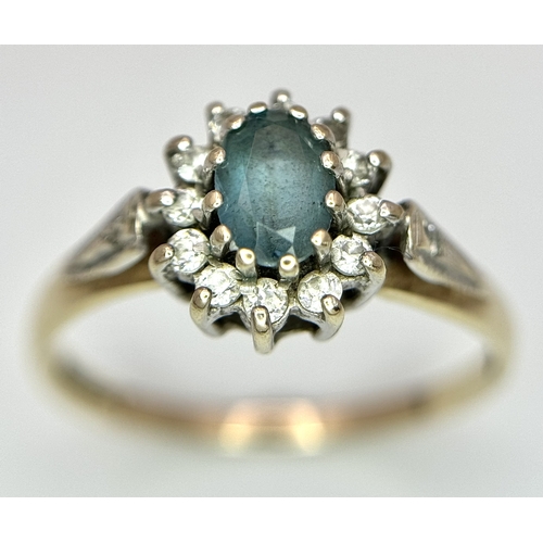 105 - Vintage 9 CARAT GOLD RING with OVAL BLUE TOURMALINE to centre with Clear Zirconia surround. 1.87 gra... 