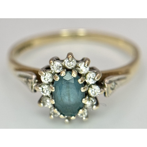 105 - Vintage 9 CARAT GOLD RING with OVAL BLUE TOURMALINE to centre with Clear Zirconia surround. 1.87 gra... 