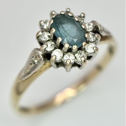 105 - Vintage 9 CARAT GOLD RING with OVAL BLUE TOURMALINE to centre with Clear Zirconia surround. 1.87 gra... 