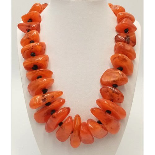 132 - A substantial, chunky necklace with orange amber resin nuggets from the Banjara tribes of Rajasthan,... 