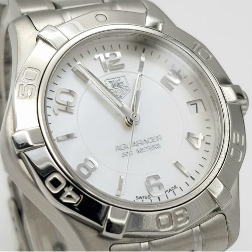 863 - A Tag Heuer 300M Aquaracer Divers Watch. Stainless steel bracelet and case - 34mm. White dial with d... 