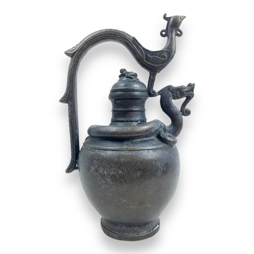 1297 - An antique Chinese Bronze Dragon and Phoenix Ewer. Cast bronze exterior with dark patina, featuring ... 