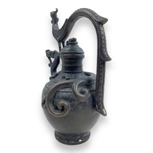 1297 - An antique Chinese Bronze Dragon and Phoenix Ewer. Cast bronze exterior with dark patina, featuring ... 