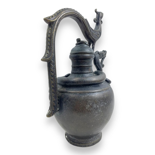 1297 - An antique Chinese Bronze Dragon and Phoenix Ewer. Cast bronze exterior with dark patina, featuring ... 