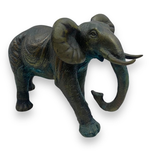 1304 - An antique Pair of Bronze Asian Elephant Sculptures. Patinated bronze exterior with intricate detail... 