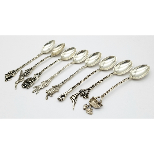 1150 - Seven Ornate 833 Silver Miniature Spoons. 8cm. 40g