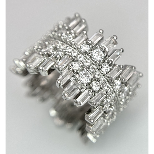 202 - A “head turning” unusual eternity ring, absolutely loaded with mesmerising baguette and round cut cu... 