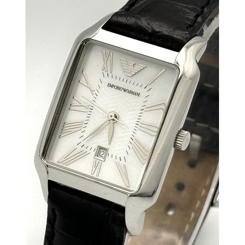 449 - An Emporio Armani Quartz Ladies Watch. Black leather strap. Stainless steel case - 26mm. White dial ... 