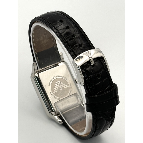 449 - An Emporio Armani Quartz Ladies Watch. Black leather strap. Stainless steel case - 26mm. White dial ... 