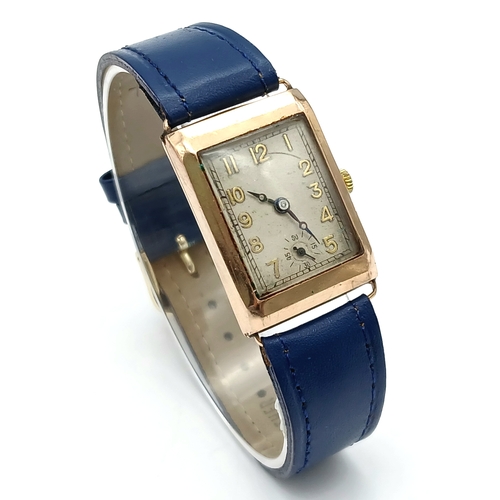 85 - A Charming Vintage (mid 1930s) Gold Cased Watch. Blue leather strap. White dial with second sub dial... 