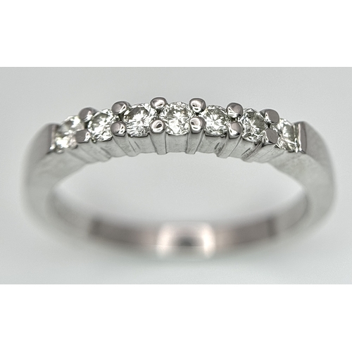 128 - AN 18K WHITE GOLD DIAMOND SET HALF ETERNITY RING 0.28CT , 3.5G TOTAL WEIGHT, SIZE N. Ref: SC 4047