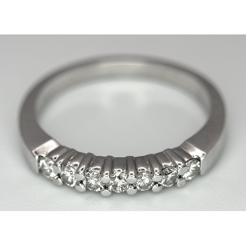 128 - AN 18K WHITE GOLD DIAMOND SET HALF ETERNITY RING 0.28CT , 3.5G TOTAL WEIGHT, SIZE N. Ref: SC 4047