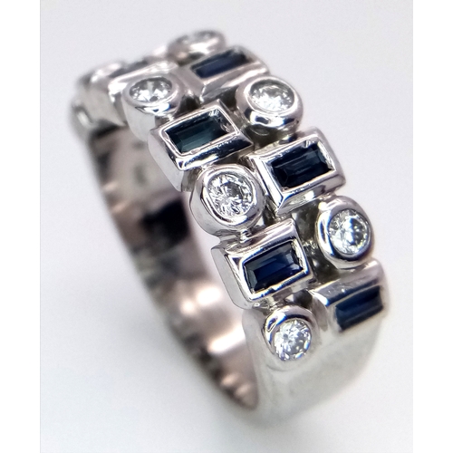 151 - A 9K WHITE GOLD DIAMOND AND SAPPHIRE RING. 6.4G. SIZE M. TAN4001.