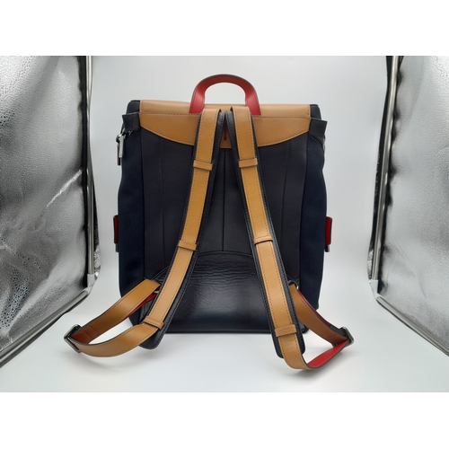 164 - A Christian Louboutin Apoloubi Backpack. Black canvas exterior with brown leather accents and gradie... 